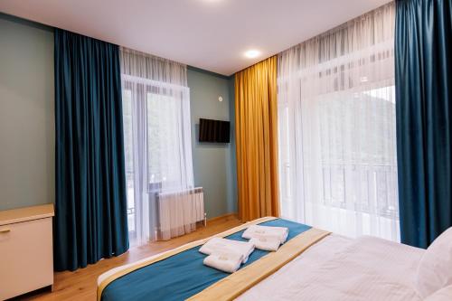 a bedroom with a bed and a large window at Dream Hotel in Haghpat