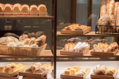 a display case filled with lots of different types of bread at Nagoya Tokyu Hotel in Nagoya