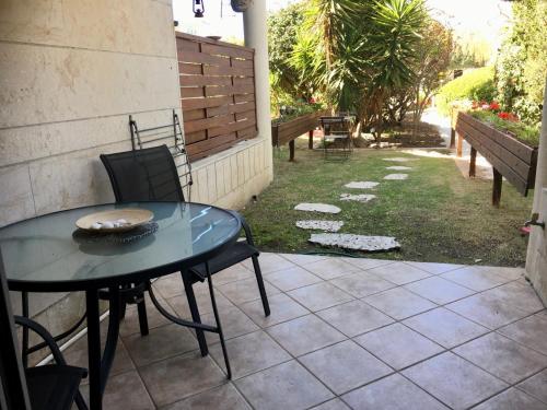 une table et des chaises assises sur une terrasse dans l'établissement Last Minute Herzliya, à Herzliya