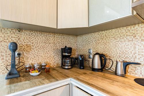 a kitchen counter top with a coffee maker on it at Entheon Olive Villas - Poolside Retreats in Marathopolis