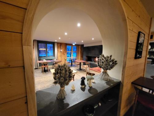 an arched doorway into a living room with a dining room at Hotel du Golf in Corrençon-en-Vercors