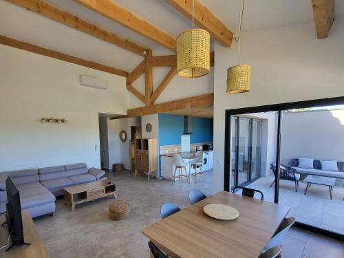 a living room with a couch and a table at Domaine de l'Envolée in Tourbes