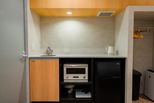 a kitchen with a counter top with a microwave at Randor Hotel Hiroshima Prestige in Hiroshima
