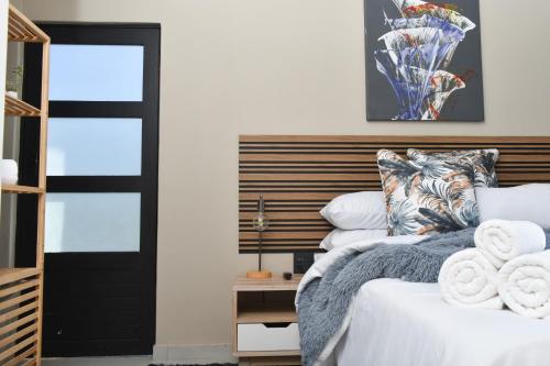 a bedroom with a bed and a black door at Falcons Rest in Pretoria