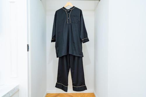 a black robe is hanging on a wall at Randor Hotel Hiroshima Prestige in Hiroshima