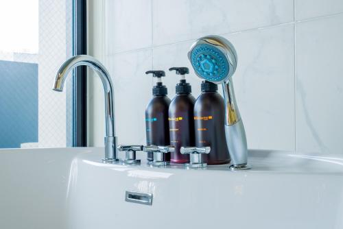 a sink with a blow dryer and two bottles on it at Randor Hotel Hiroshima Prestige in Hiroshima