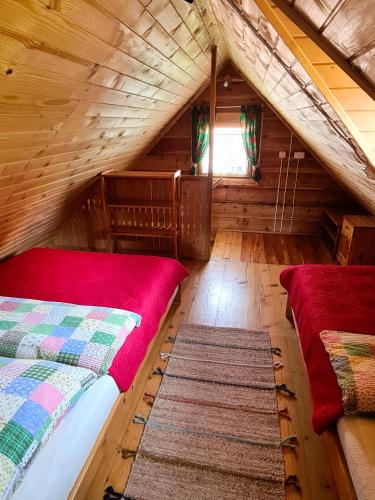 a bedroom with two beds in a log cabin at Domki Pod Horbem in Polańczyk