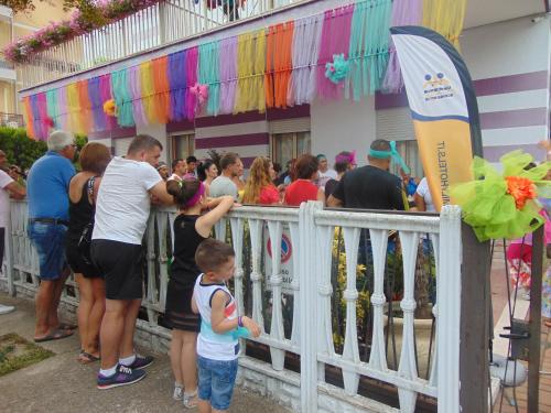 a crowd of people standing outside of a building at Hotel Germania in Lido di Jesolo