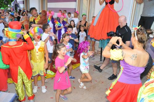 a group of children dancing in front of a crowd of people at Hotel Germania in Lido di Jesolo
