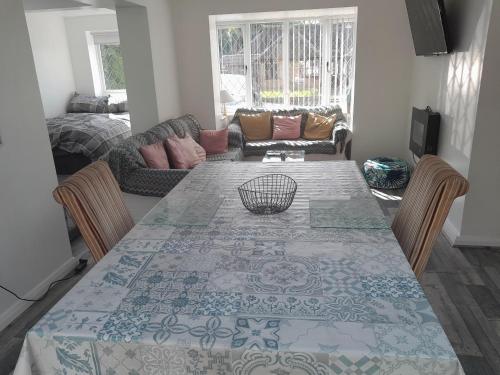 a living room with a table and a couch at One bed stunning apartment with parking right outside, close to Burton town centre in Burton upon Trent