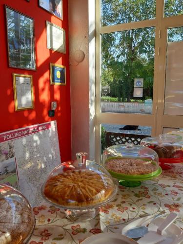 a table with several trays of food on it at B&B Cuoreverde Pollino in Rotonda