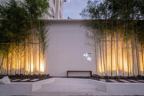 a building with a wall with trees on it at Aank Hotel Daejeon Yongjeon 2nd in Daejeon