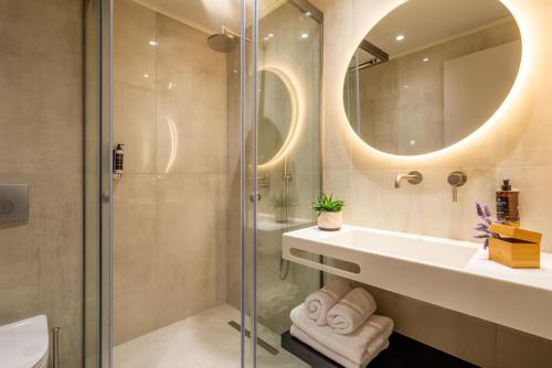 a bathroom with a sink and a shower at Hara Suites in Parga