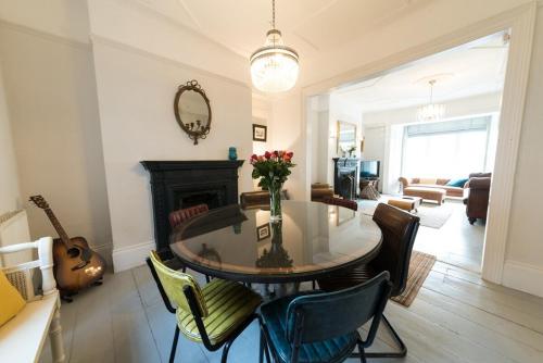 a living room with a table and a fireplace at Sea Front St Leonards in Hastings