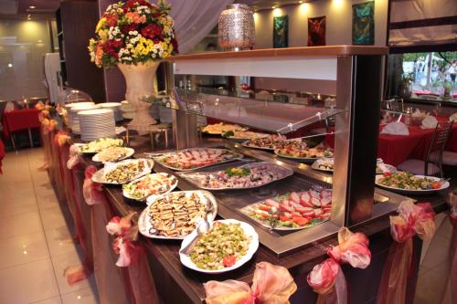 a buffet line with many different plates of food at Hotel Germania in Lido di Jesolo