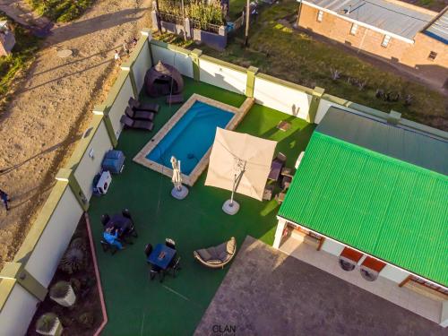 an overhead view of a house with a swimming pool at The Clan Guest House in Maseru