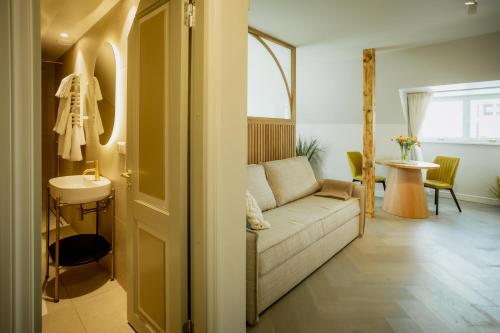 a living room with a couch and a sink at Güldenstubbe Residences in Kuressaare