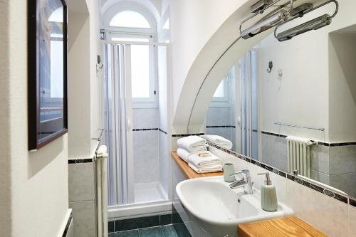 a bathroom with a sink and a mirror at Il Moderno by Holiday Solutions in Como