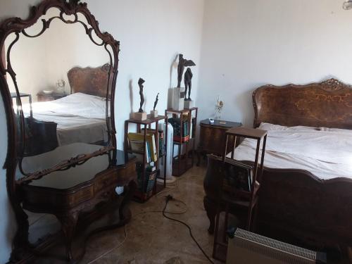 a room with two beds and a mirror at Spacious room in Marghera