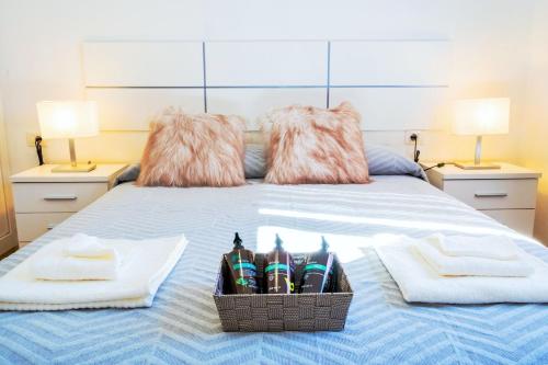a bed with two towels and a basket of toothbrushes at Live Caletillas Taunus in Candelaria