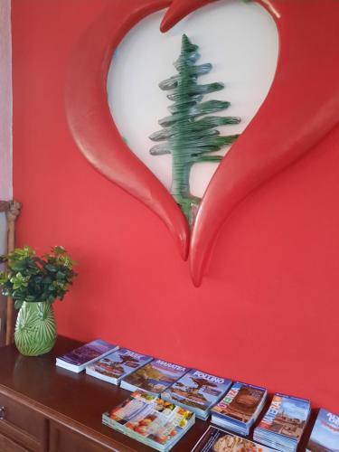 a heart shaped wall with a book shelf with a tree in it at B&B Cuoreverde Pollino in Rotonda