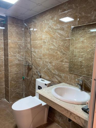 a bathroom with a toilet and a sink and a shower at My Dream Hotel in Sapa