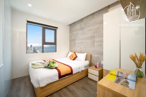 a bedroom with a bed and a window at Kim Ngan Phat Deluxe Apartment in Danang