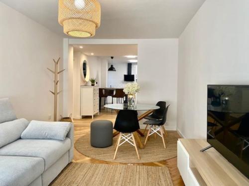 a living room with a couch and a table at CENTRO GIJON CABRALES 31 in Gijón