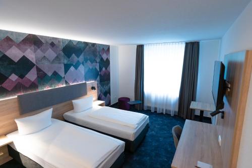 Katil atau katil-katil dalam bilik di Taste Hotel Jettingen