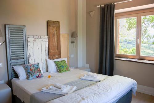 a bedroom with two beds with towels on them at Casa Bartoccio - Casa vacanze in Fermignano