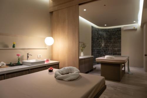 a bathroom with a sink and a bath tub at Areca Resort and Spa - SHA Extra Plus in Kathu