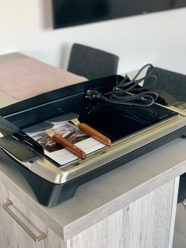 a black suitcase sitting on a table with a purse at AirbnbTřeboň - modern apartment in Třeboň
