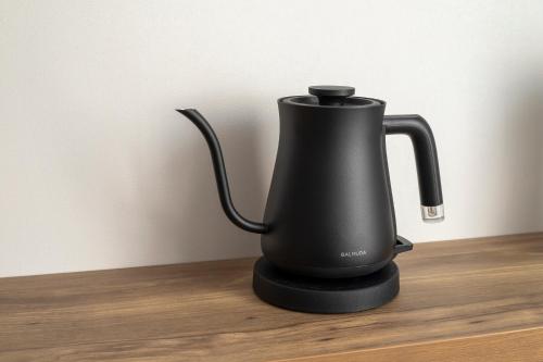 a black electric kettle sitting on a wooden table at Tokyu Stay Hakodate Asaichi Akarinoyu in Hakodate