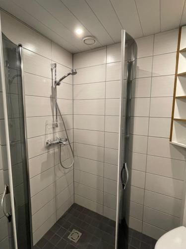 a shower with a glass door in a bathroom at UPTOWN Hotel Apartments in Stockholm