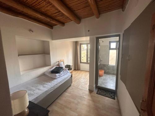 a room with a bed and a mirror in it at mandarava homestay in Leh