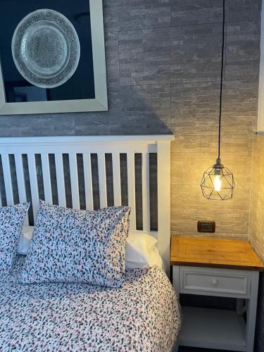 a bedroom with a bed and a table with a plate on it at Apartamentos Finca Wapa in Frontera