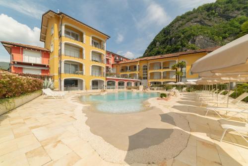 un hotel con piscina frente a un edificio en Yachting Residence, en Lavena Ponte Tresa