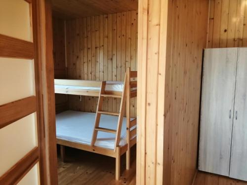 a room with a bunk bed and a chair in it at Zielona Polana 