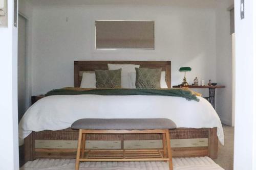a bedroom with a large bed with a wooden headboard at Wandana holiday homes in Port Lincoln