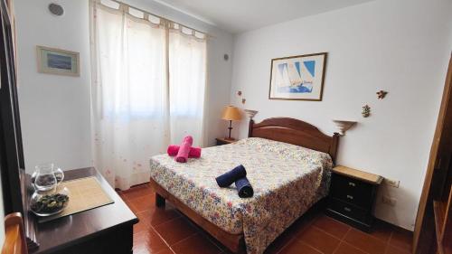a bedroom with a bed with a pair of shoes on it at Sweet Flat with private patio Dunasol in Corralejo