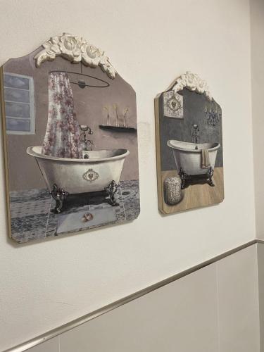 two pictures of a bath tub on a wall at LA CASA DEL FALEGNAME in Laterina