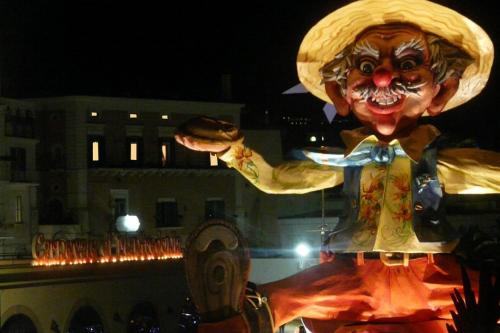 a person dressed up in a clown costume at night at La Dolce Vista - B&B di Charme in Manfredonia