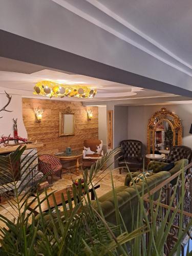a living room with a couch and chairs at Zwei Hirsche in Seefeld in Tirol