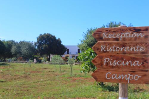 a wooden sign that saysreforestationrectionritisrectionrativeerateerateerateporapora at Tenuta Ferraro Gallipoli in Gallipoli