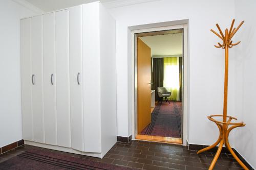 a room with white wardrobes and a hallway at Apartment Vujovic in Kladovo