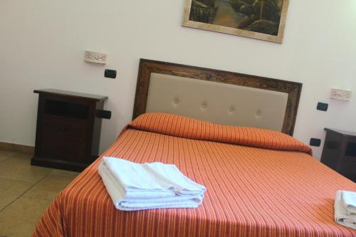 a bedroom with a bed with two towels on it at Tenuta Ferraro Gallipoli in Gallipoli