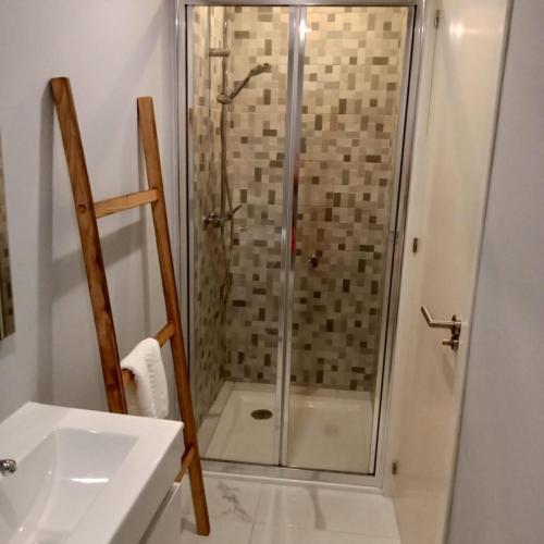 a bathroom with a shower and a sink at Ancoradouro T1 - Alojamento Local Gerês in Braga