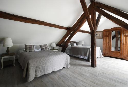 a bedroom with two beds in a attic at Château - Hôtel Le Sallay in Magny-Cours