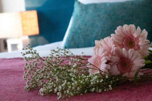 a bouquet of pink flowers sitting on a table at Rooms at The Marine in Ballybunion
