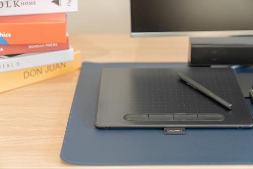 a laptop computer with a pen sitting on a desk at Aank Hotel Cheonan Station 2nd in Cheonan